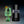 Load image into Gallery viewer, Green cocktail in a glass with a black ice ball press, ice sphere maker by pressice barware on a gradient background
